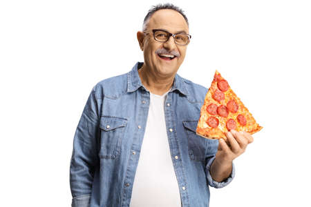 Happy mature man holding a slice of pepperoni pizza and smiling isolated on white backgroundの写真素材