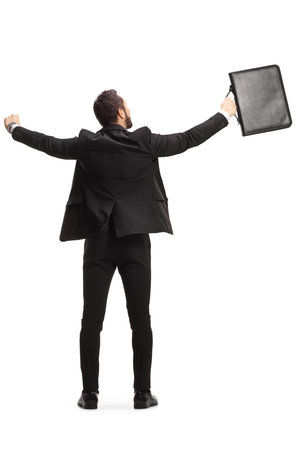 Rear view shot of a businessman with a briefcase celebrating success isolated on white backgroundの写真素材