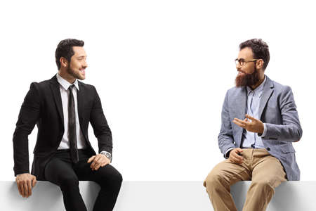 Professional men sitting on a blank panel and talking isolated on white background