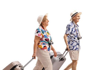 Elderly tourists with suitcases walking isolated on white background