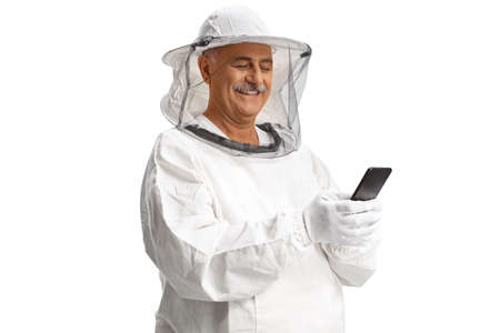Mature male bee keeper in a uniform using a smartphone isolated on white background