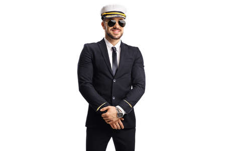 Young pilot in a uniform wearing sunglasses and posing isolated on white background