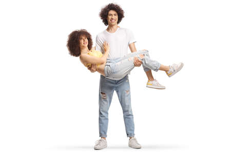 Happy young man carrying a girl in his hands isolated on white background