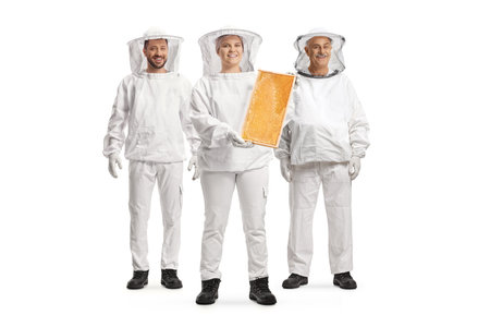 Group of bee keepers in uniforms with a honeycomb frame isolated on white backgroun