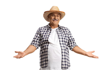 Happy mature farmer with a straw hat gesturing with hands isolated on white backgroundの写真素材