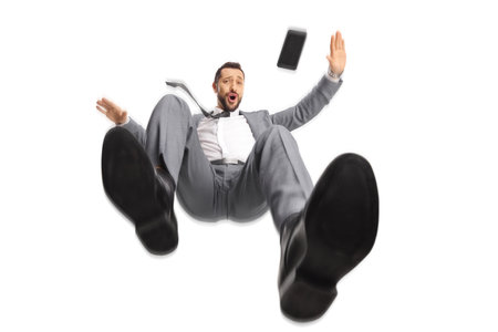 Professional man with a mobile phone falling isolated on white background