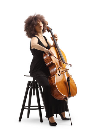 Woman in a black dress sitting on a chair and playing a cello isolated on white backgroundの写真素材