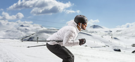 Profile shot of a male skier skiing on a mountain