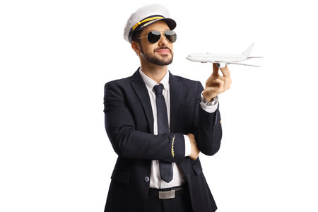 Pilot holding a small airplane model isolated on white backgroundの写真素材