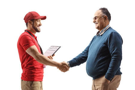 Profile shot of a delivery man shaking hands with a mature man isolated on white background