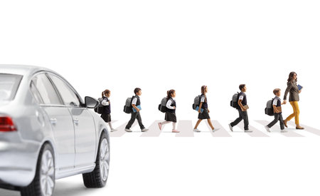 Car waiting at a pedestrian crossing and schoolchildren crossing street with teacher isolated on...