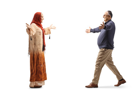 Muslim woman in ethnic clothes meeting a mature man isolated on white backgroundの写真素材