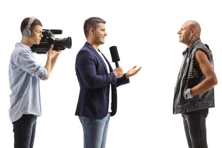 TV reporter and a cameraman interviewing a punk isolated on white backgroundの写真素材