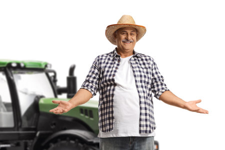 Smiling mature farmer with a straw hat gesturing with hands isolated on white backgroundの写真素材
