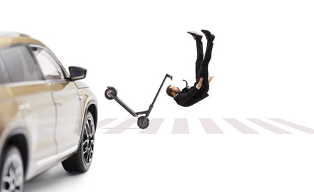 Professional man in a suit and tie falling from an electric scooter at a pedestrian crossing in front of a suv isolated on white backgroundの写真素材