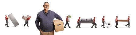 Movers carrying items and a mature male customer holding a cardboard box and smiling at camera isolated on white backgroundの写真素材