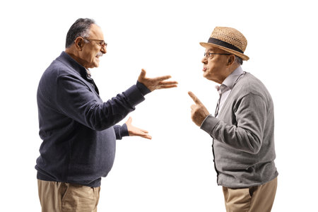 Profile shot two mature men having an argument isolated on white backgroundの写真素材