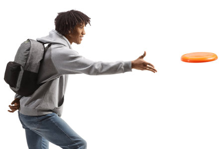 Young african american man throwing a flying disc isolated on white backgroundの写真素材