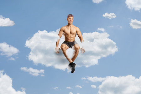 Shirtless bodybuilder sitting on a cloud up in the skyの写真素材