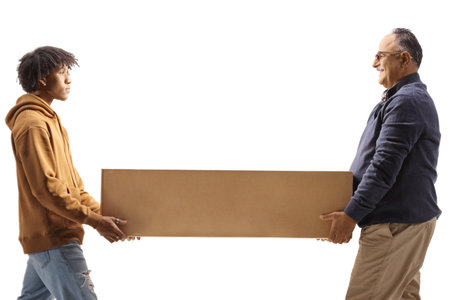 Mature man and a young african american man carrying a cardboard box togeather isolated on white...