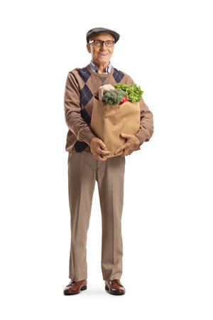 Grandpa standing and holding a bag of groceries isolated on white backgroundの写真素材