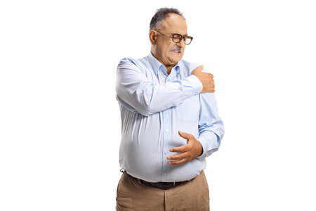 Mature man with pain in shoulder isolated on white backgroundの写真素材
