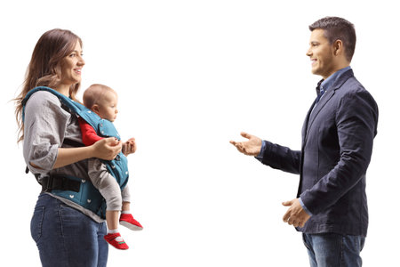 Profile shot of a man talking to a mother with a baby in a carrier isolated on white backgroundの写真素材