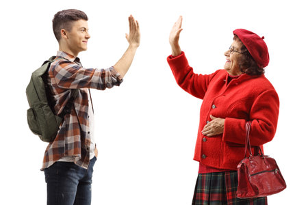 Profile shot of a male student gesturing high-five with an elderly woman isolated on white backgroundの写真素材