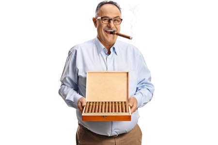 Mature man with a box of cuban cigars isolated on white backgroundの写真素材