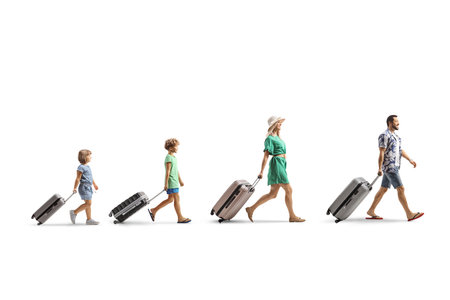 Family with children walking and pulling suitcases isolated on white backgroundの写真素材
