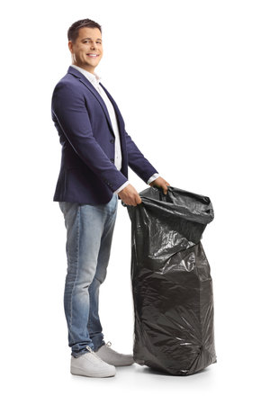 Man holding a black plastic bin bag isolated on white backgroundの写真素材