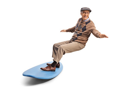 Elderly man trying a surfing board isolated on white background