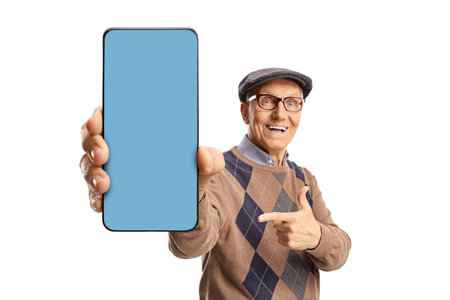 Senior man showing a smartphone with blue screen in front of camera isolated on white backgroundの写真素材