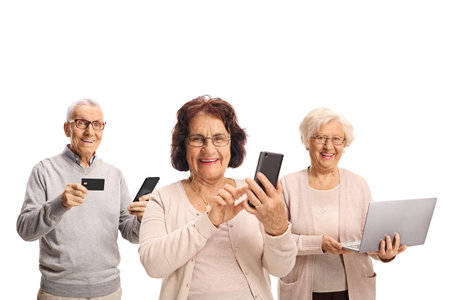 Happy senior people with a laptop computer and smartphones isolated on white background