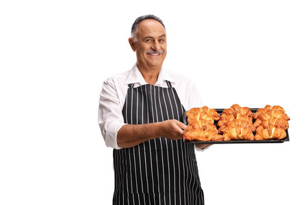 Man holding a tray with croissants isolated on white background