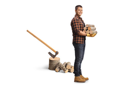 Man carrying wood trunks and cutting trees with an axe isolated on white backgroundの写真素材