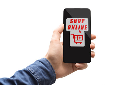 Male hand holding a smartphone with shop online sign isolated on white backgroundの写真素材
