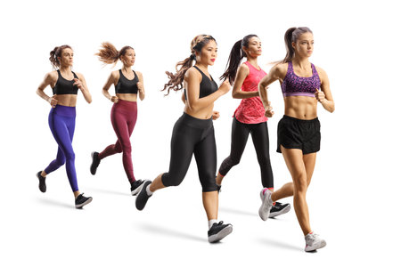 Group of young women running a race isolated on white backgroundの写真素材