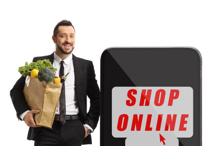 Businessman with a grocery bag and online shopping sign isolated on white backgroundの写真素材