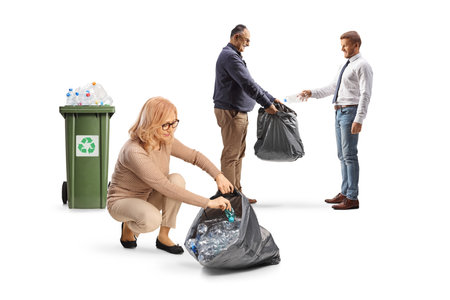 Two men and a woman collecting plastic bottles for recycling isolated on white backgroundの写真素材