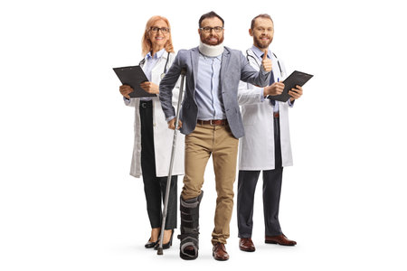 Man with a team of doctors recovering from injury isolated on white backgroundの写真素材