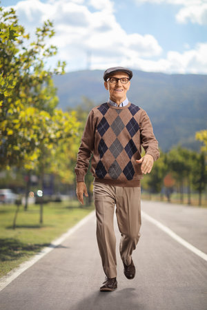 Full length portrait of a senior gentleman walking in a parkの写真素材