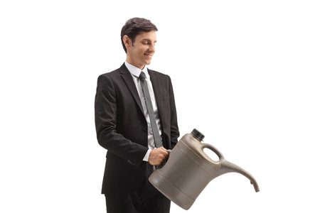 Businessman holding a watering cansiter isolated on white backgroundの写真素材
