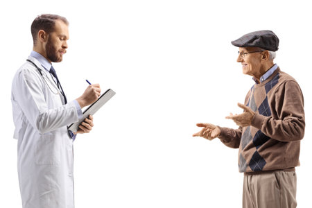 Doctor writing a prescription for an elderly male patient isolated on white backgroundの写真素材
