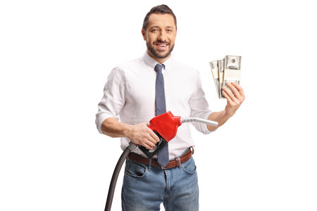Man holding a petrol gun and money isolated on white backgroundの写真素材