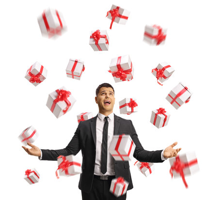 Businessman gesturing with hands and looking towards presents in the air isolated on white backgroundの写真素材