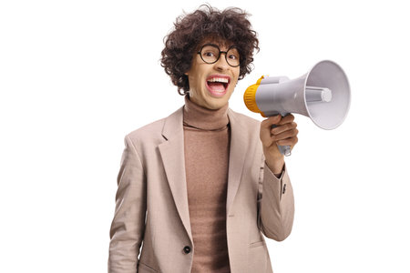 Young man shouting and holding a megaphone isolated on white backgroundの写真素材