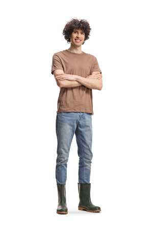 Guy wearing garden rubber boots isolated on white backgroundの写真素材