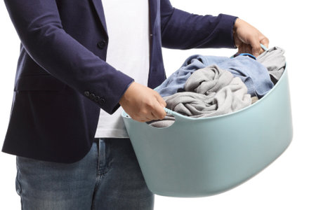 Man holding a laundry basket isolated on white backgroundの写真素材