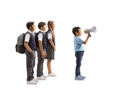 Schoolchildren behind a kid shouting and holding a megaphone isolated on white background